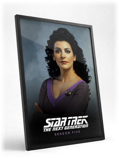 Star Trek: The Next Generation poster in a black frame with glass leaning against a wall
