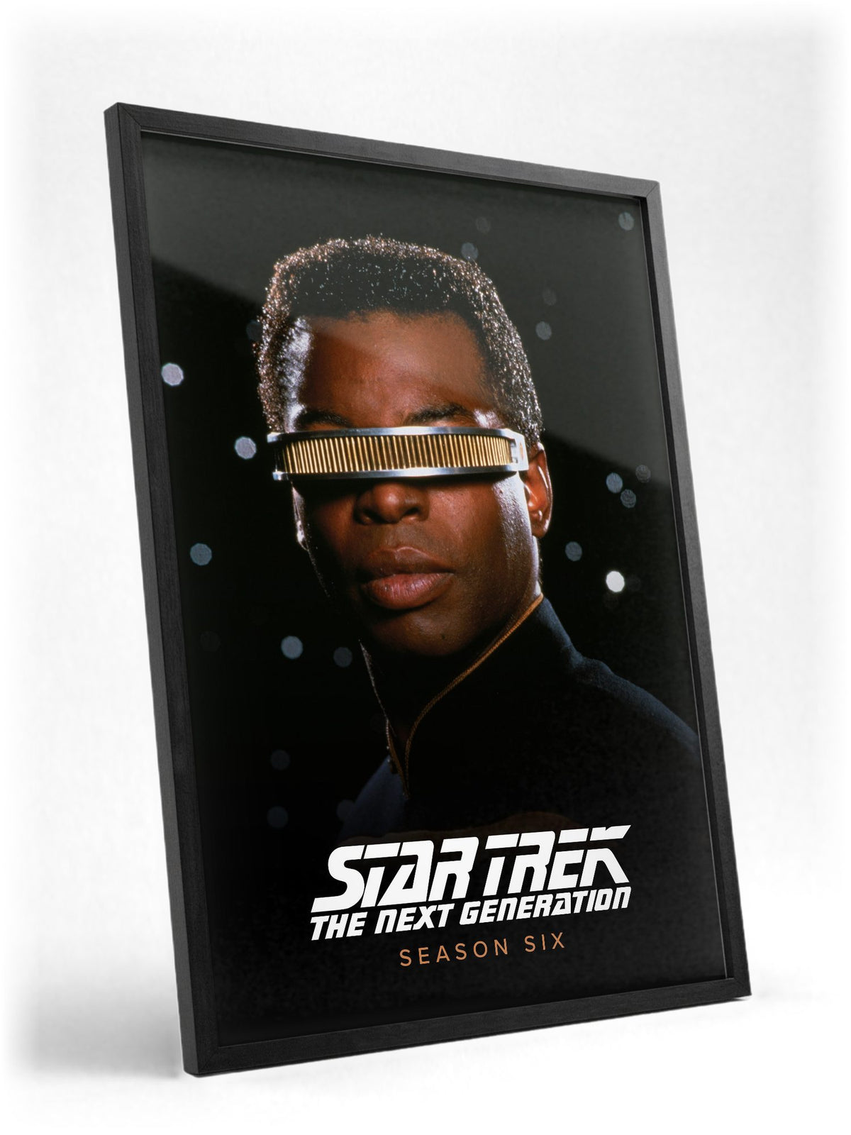 Star Trek: The Next Generation poster in a black frame with glass leaning against a wall