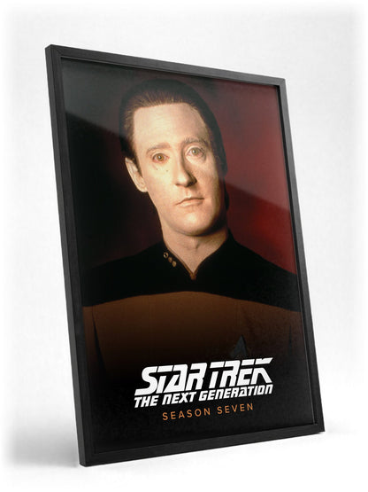 Star Trek: The Next Generation poster in a black frame with glass leaning against a wall