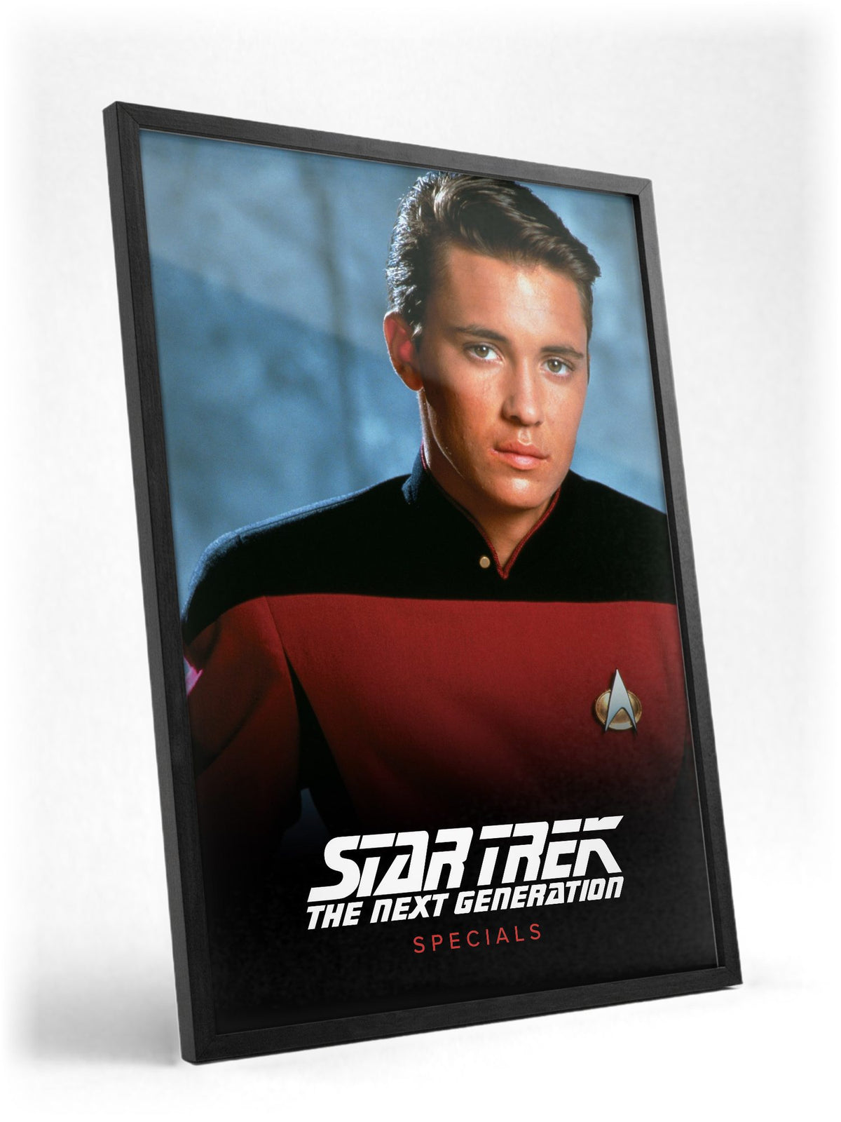 Star Trek: The Next Generation poster in a black frame with glass leaning against a wall