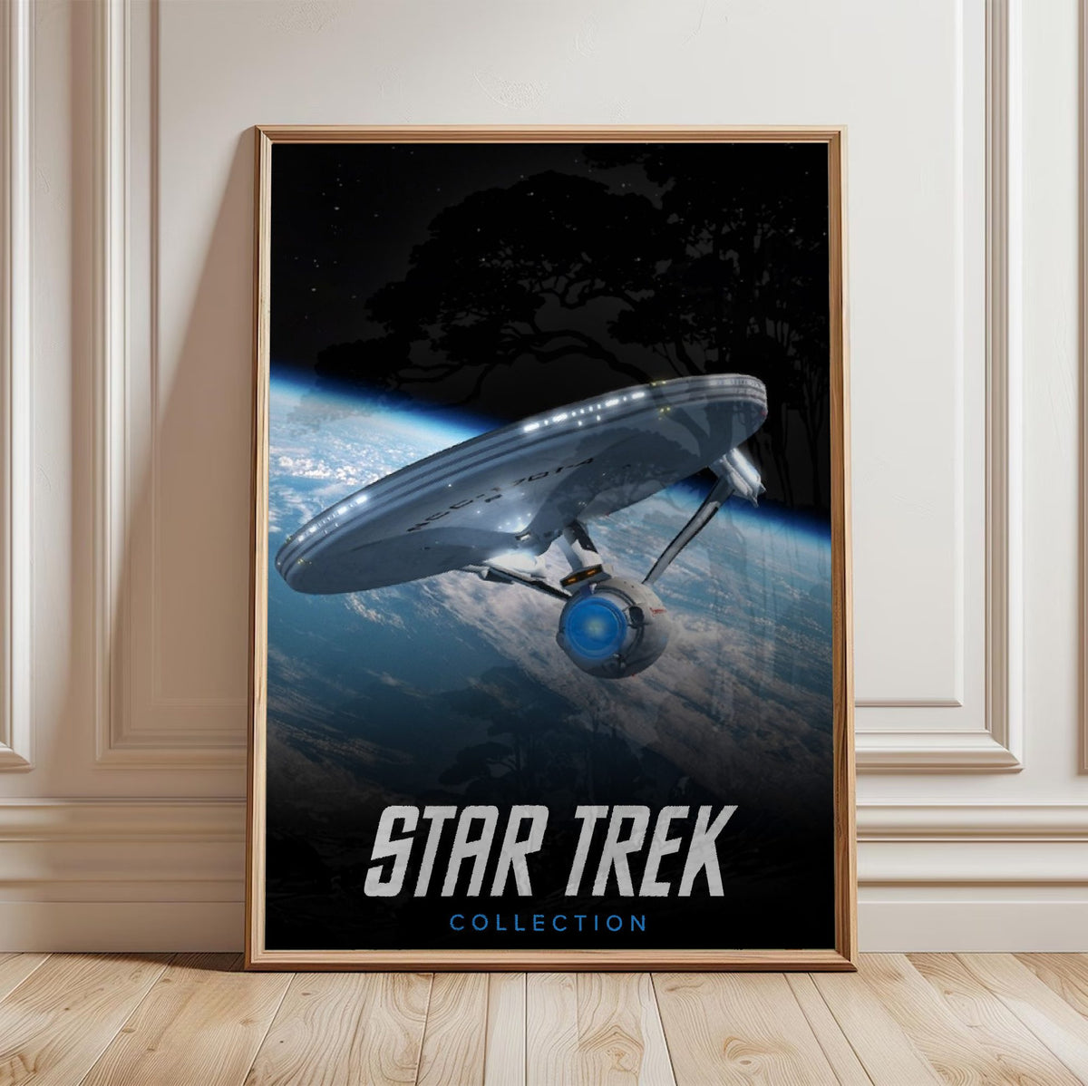 Star Trek TV Collection Art poster in a light oak frame leaning against a white wall