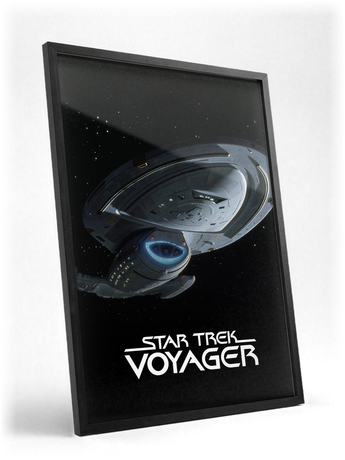 Star Trek: Voyager poster in a black frame with glass leaning against a wall