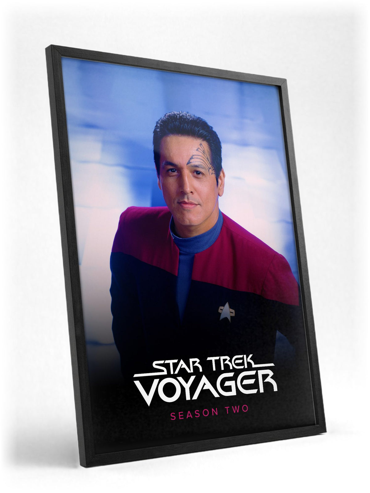 Star Trek: Voyager poster in a black frame with glass leaning against a wall