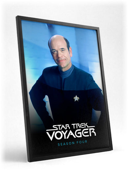 Star Trek: Voyager poster in a black frame with glass leaning against a wall