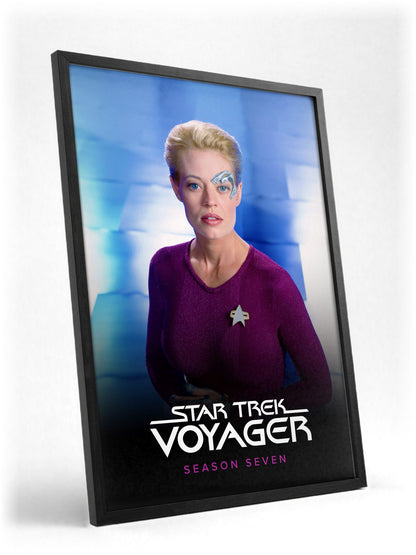 Star Trek: Voyager poster in a black frame with glass leaning against a wall