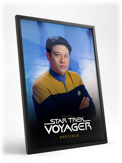Star Trek: Voyager poster in a black frame with glass leaning against a wall