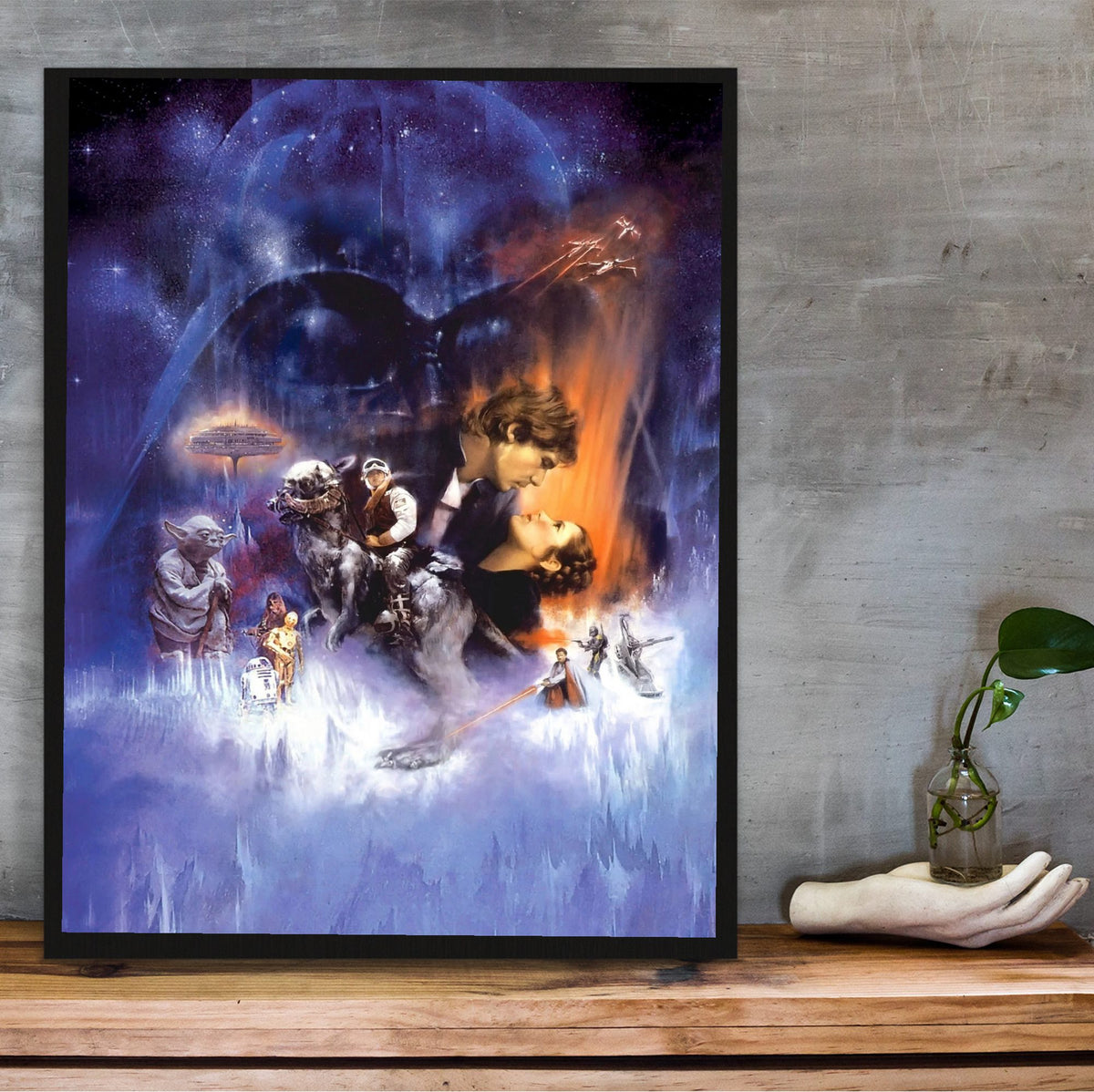 Star Wars: The Empire Strikes Back (1980) Movie Painted Art poster in a black frame on a wooden shelf against concrete