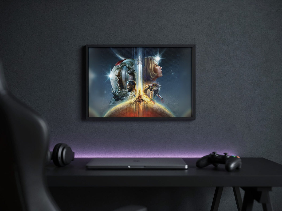 Starfield Key Art poster in a black frame above a gaming desk