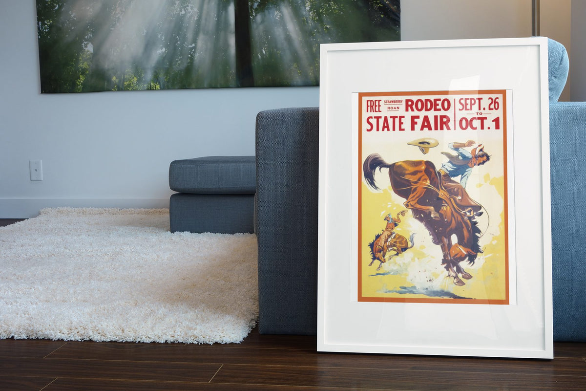 State Fair Rodeo Bronc Rider poster leaning beside a blue sofa