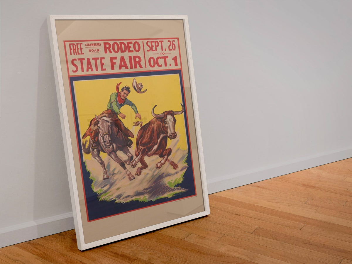 State Fair Rodeo Steer Wrestler poster in a white frame leaning against a wall