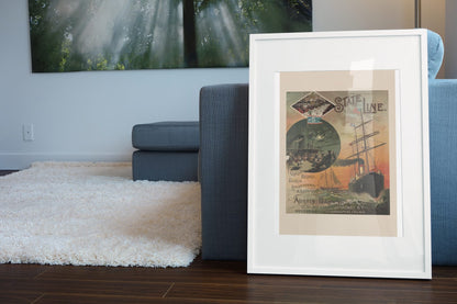 State Line Steamship to Europe poster leaning beside a blue sofa