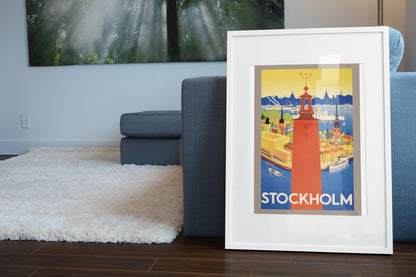 Stockholm Sweden poster leaning beside a blue sofa