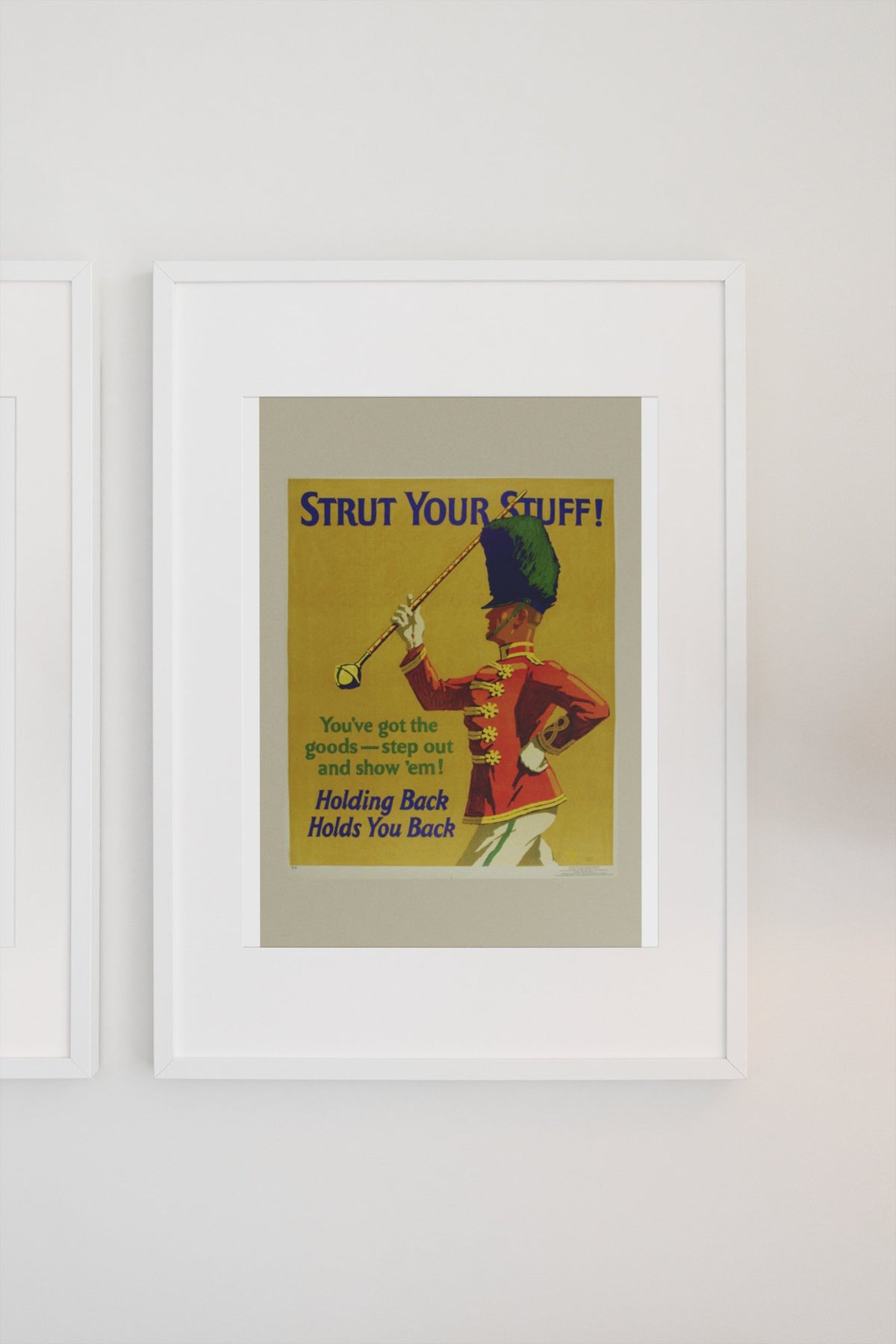 Strut Your Stuff poster in a white frame on a light wall
