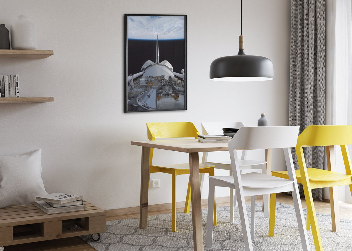 STS-123 Space Shuttle leaving the ISS poster framed above a dining table