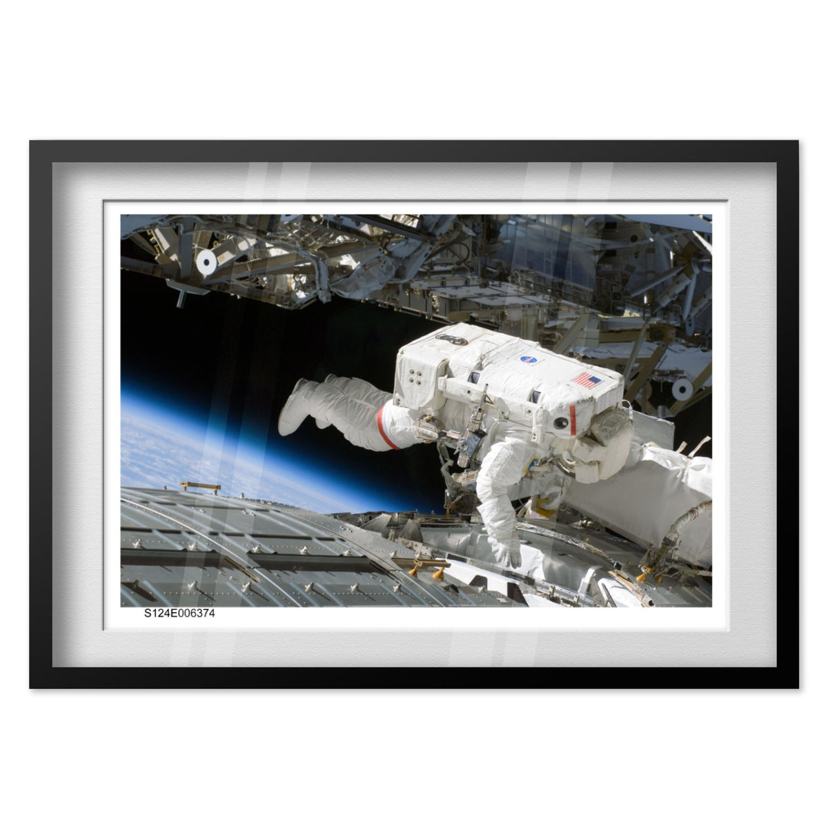STS-124 Discovery astronaut spacewalk poster in a black frame