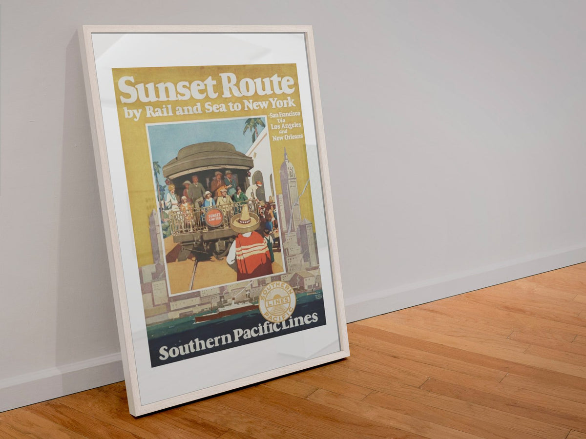 Sunset Route Southern Pacific poster in a white frame leaning against a wall