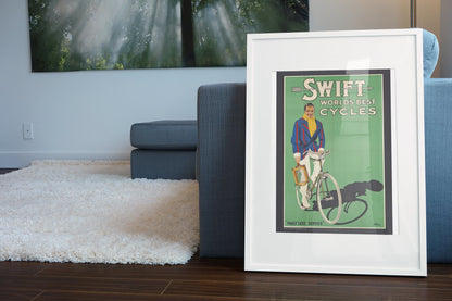 Swift Worlds Best Cycles poster leaning beside a blue sofa