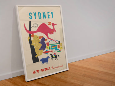 Sydney Air India poster in a white frame leaning against a wall