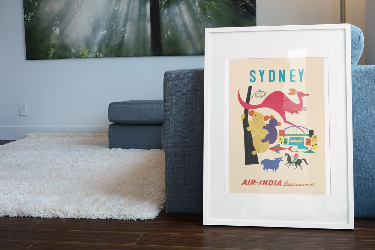 Sydney Air India poster leaning beside a blue sofa
