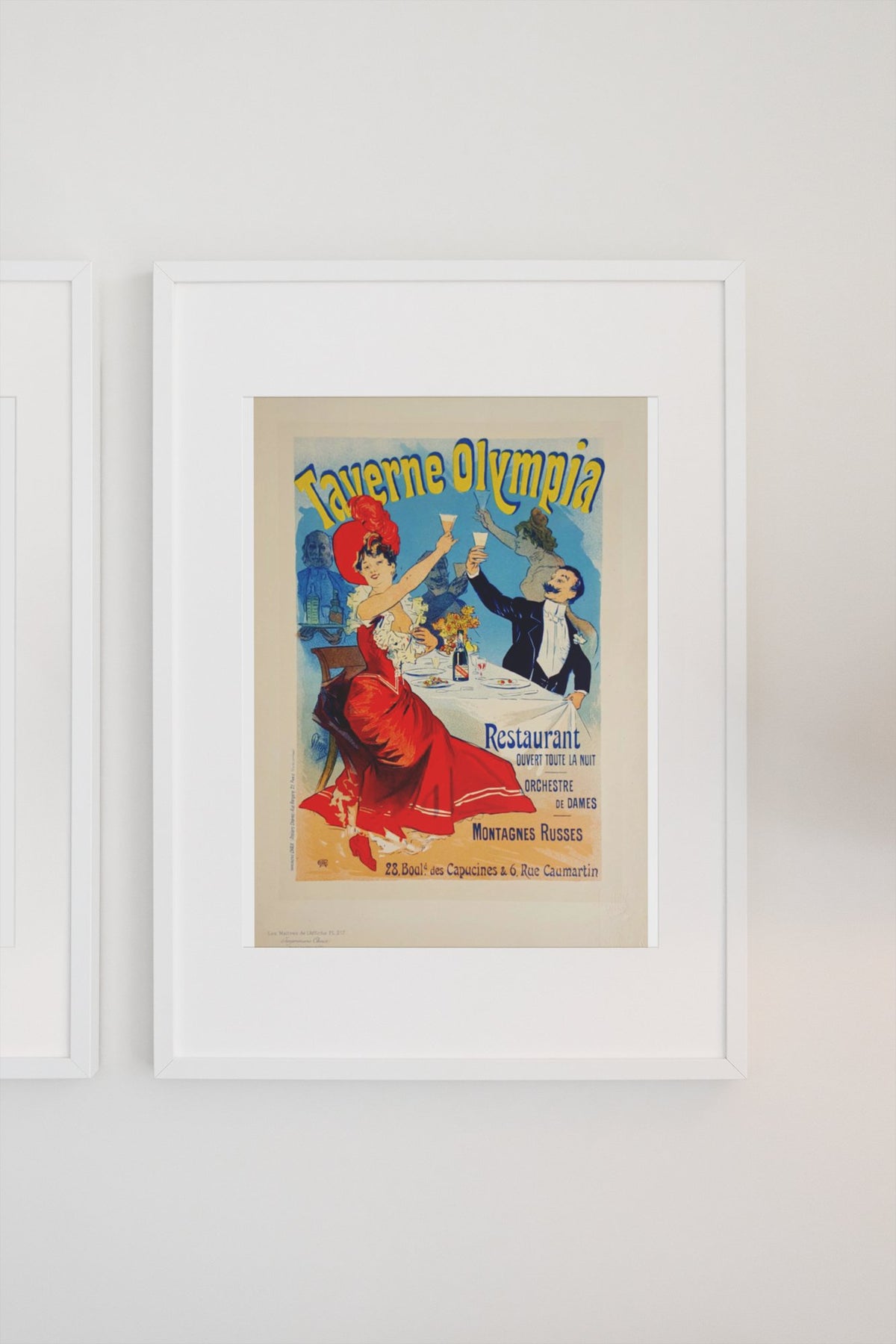 Taverne Olympia 1900 poster in a white frame on a light wall