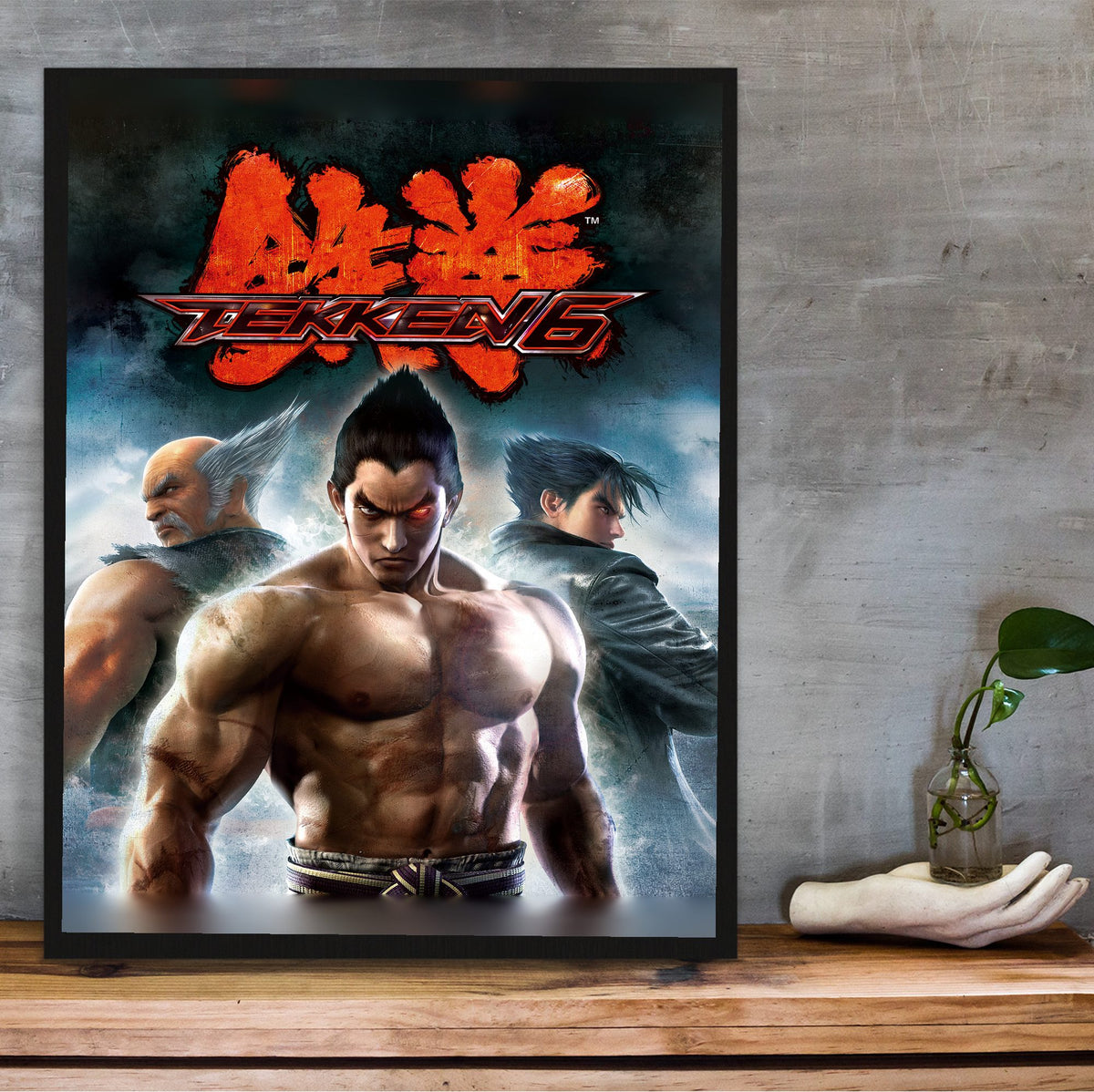 Tekken 6 Promo Art Print 2 poster in a black frame on a wooden shelf against concrete