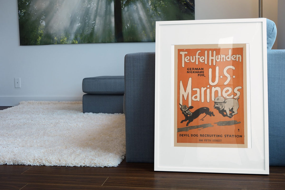 Teufel Hunden Devil Dog US Marines poster leaning beside a blue sofa