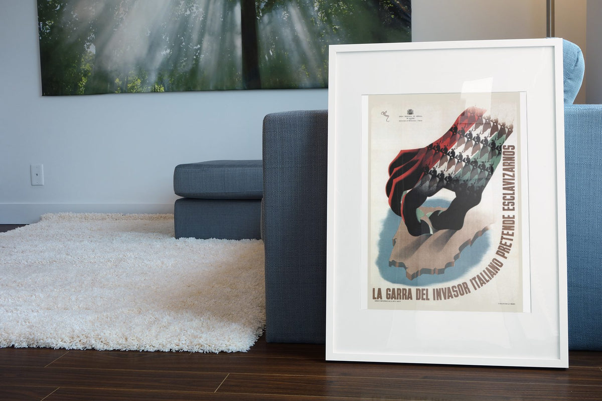 The Claw La Garra poster leaning beside a blue sofa