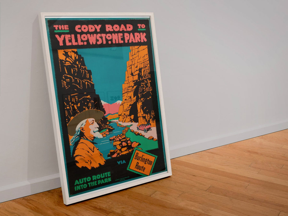 Cody Road to Yellowstone poster in a white frame leaning against a wall