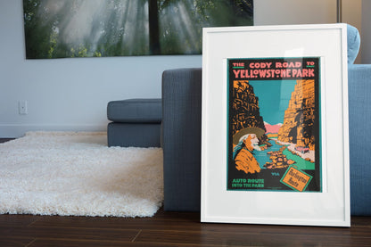 Cody Road to Yellowstone poster leaning beside a blue sofa