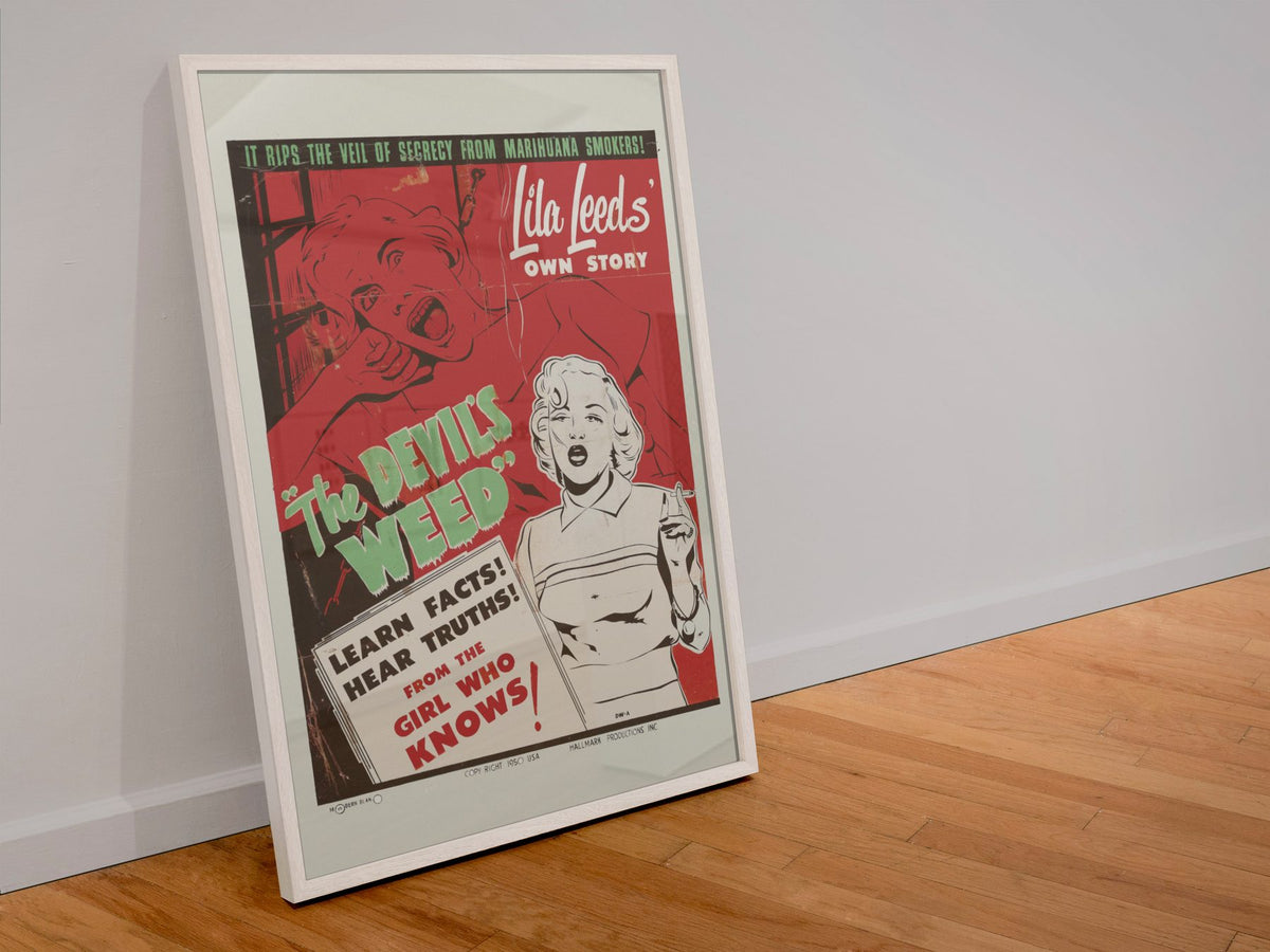 The Devils Weed poster in a white frame leaning against a wall