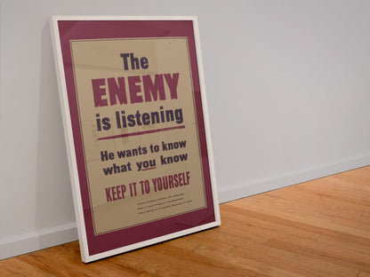 The Enemy Is Listening poster in a white frame leaning against a wall