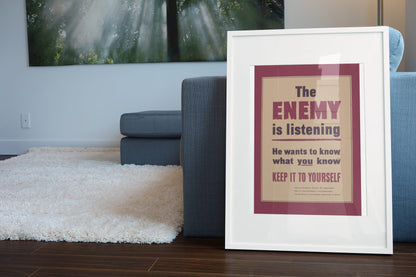 The Enemy Is Listening poster leaning beside a blue sofa
