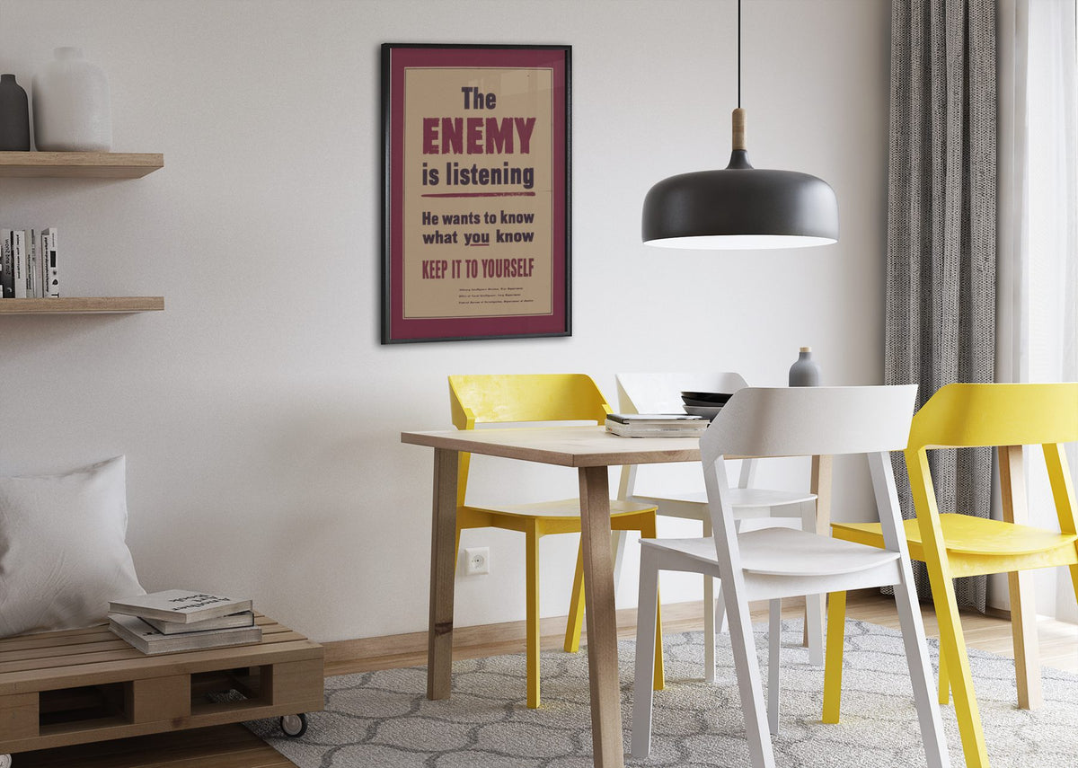 The Enemy Is Listening poster framed above a dining table