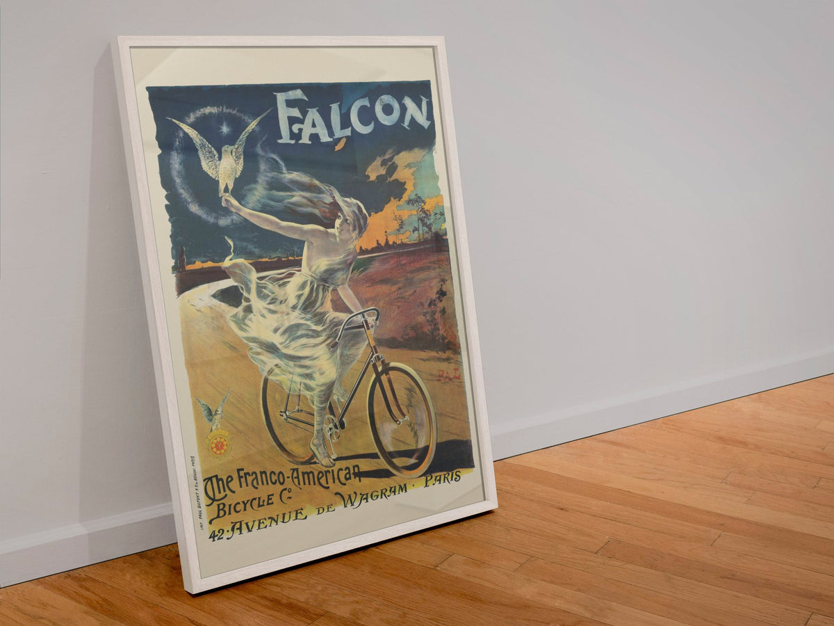 The Falcon Bicycle poster in a white frame leaning against a wall