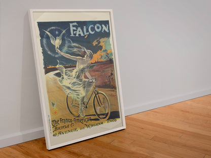 The Falcon Bicycle poster in a white frame leaning against a wall