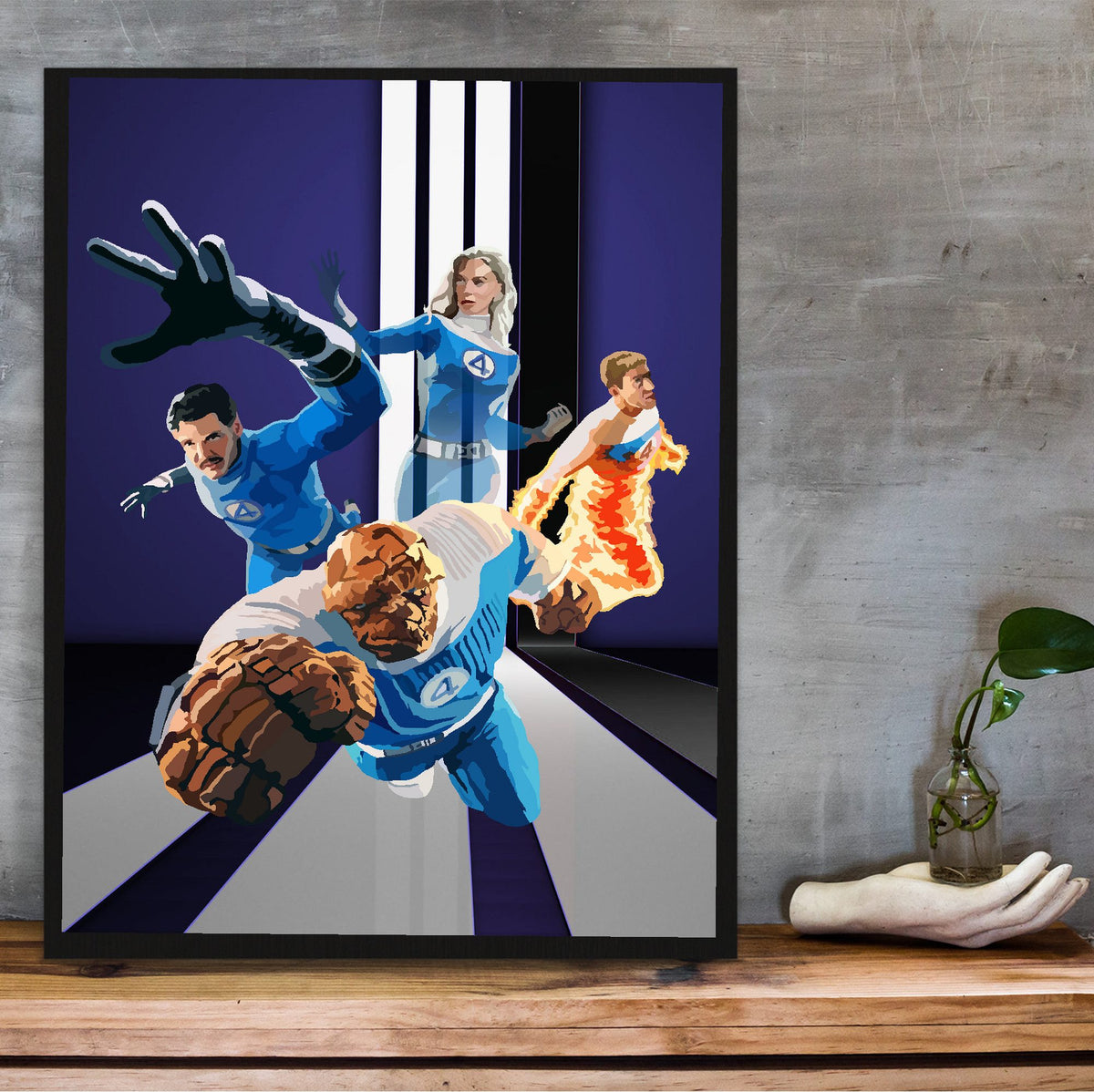 The Fantastic Four: First Steps (2025) Movie Retro Art poster in a black frame on a wooden shelf against concrete