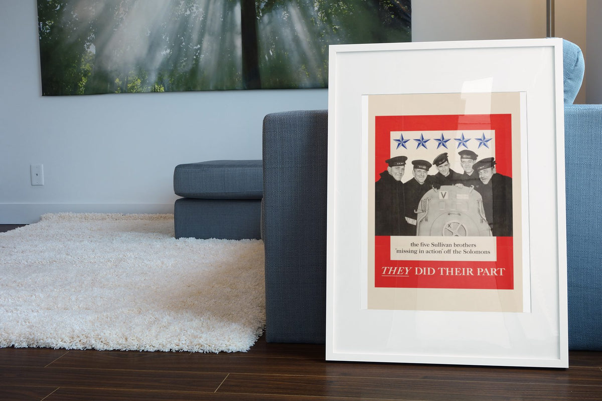The Five Sullivan Brothers — They Did Their Part poster leaning beside a blue sofa