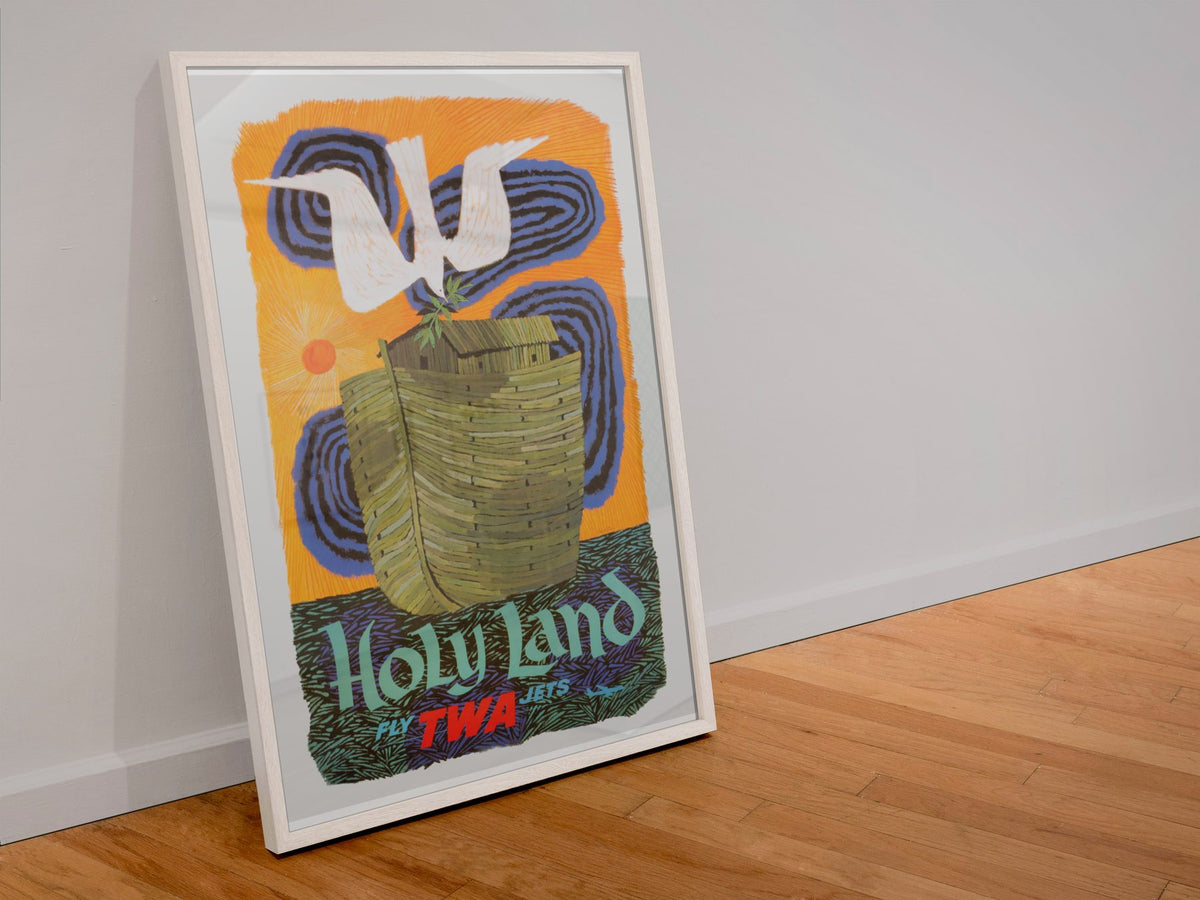 Holy Land Fly TWA poster in a white frame leaning against a wall