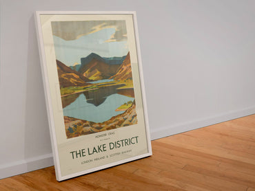 The Lake District poster in a white frame leaning against a wall