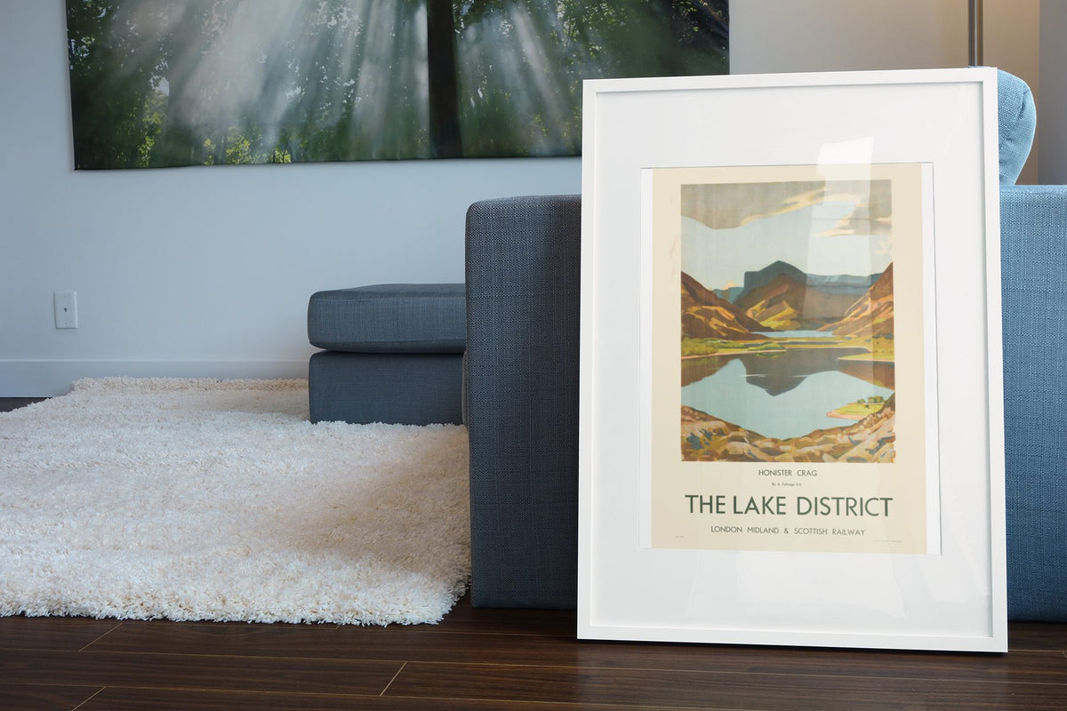The Lake District poster leaning beside a blue sofa