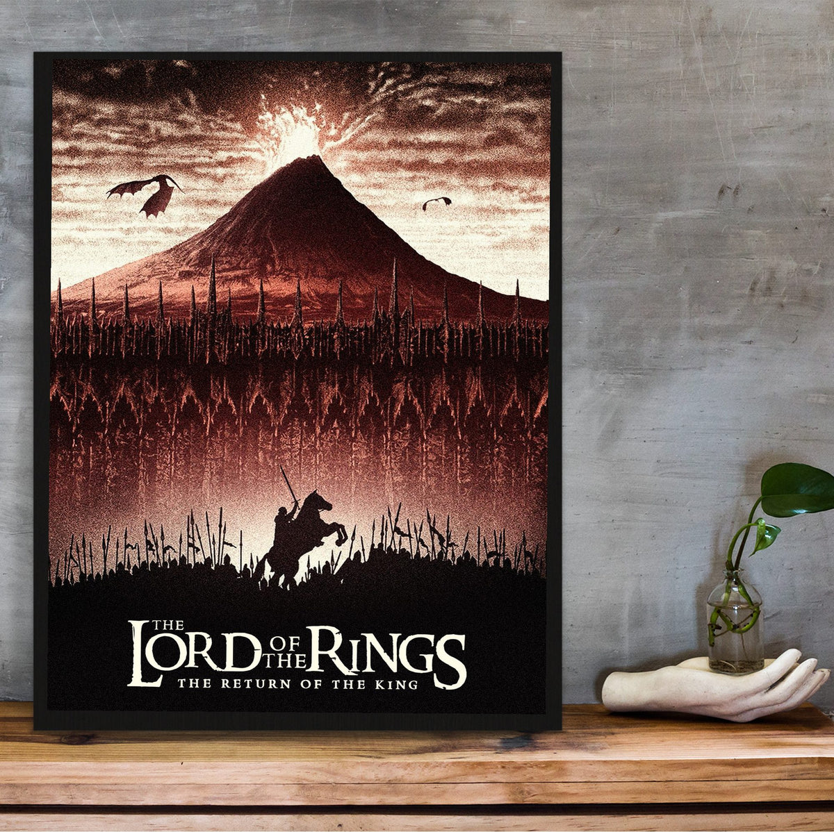 The Lord of the Rings: The Return of the King (2003) Mount Doom Art poster in a black frame on a wooden shelf against concrete