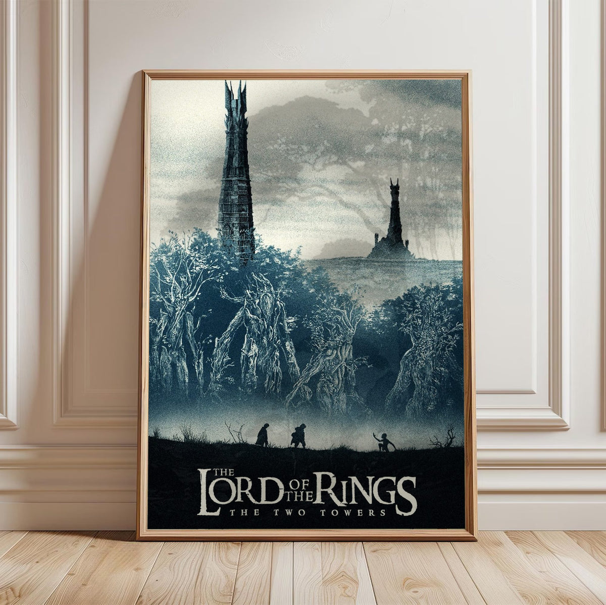 The Lord of the Rings: The Two Towers (2002) Movie Two Towers Art poster in a light oak frame leaning against a white wall