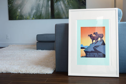 The National Parks Preserve Wild Life poster leaning beside a blue sofa