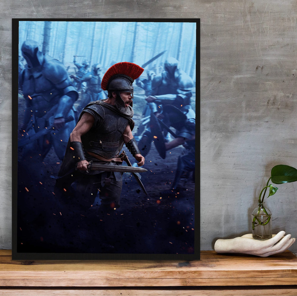 The Odyssey (2026) Movie Battle Art poster in a black frame on a wooden shelf against concrete