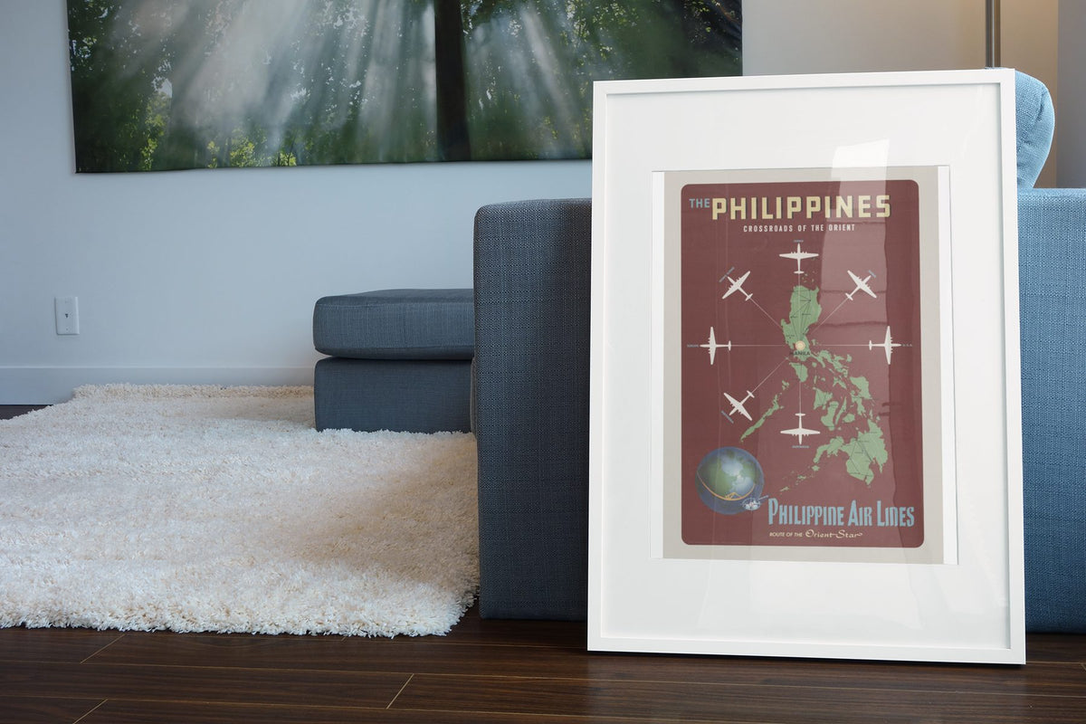 Philippines Crossroads of the Orient poster leaning beside a blue sofa