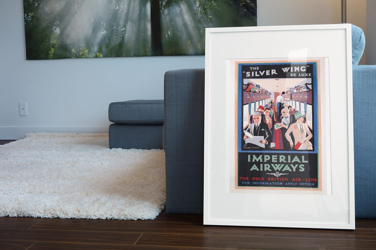 Silver Wing Imperial Airways poster leaning beside a blue sofa