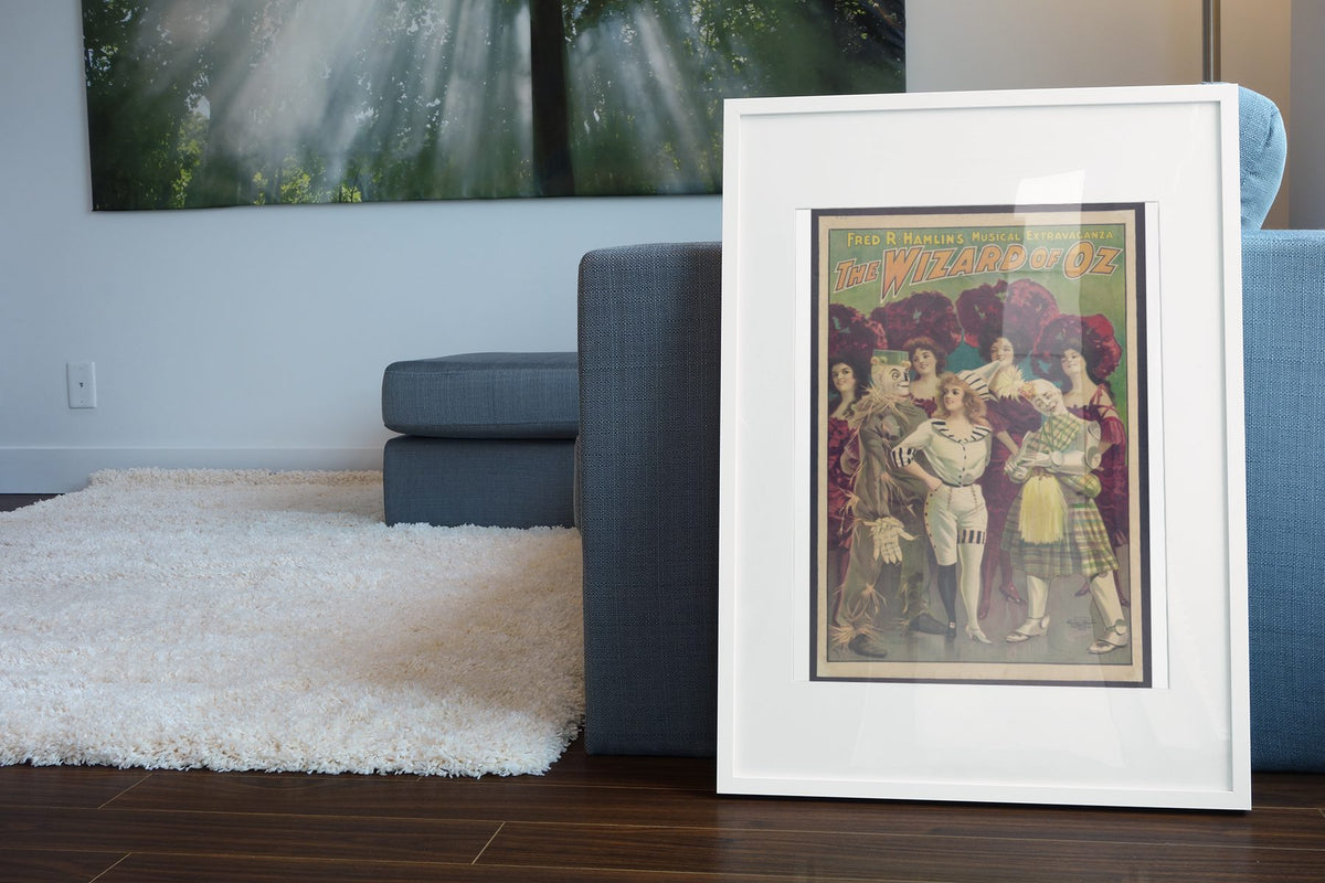 The Wizard of Oz Stage Musical poster leaning beside a blue sofa