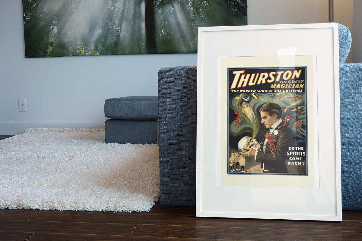 Thurston the Great Magician poster leaning beside a blue sofa