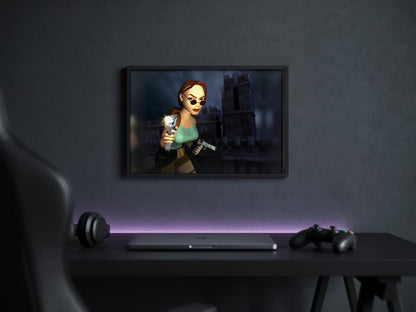 Tomb Raider III Key Art poster in a black frame above a gaming desk