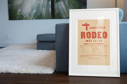 Tombstone Rodeo Open to All Cowboys poster leaning beside a blue sofa